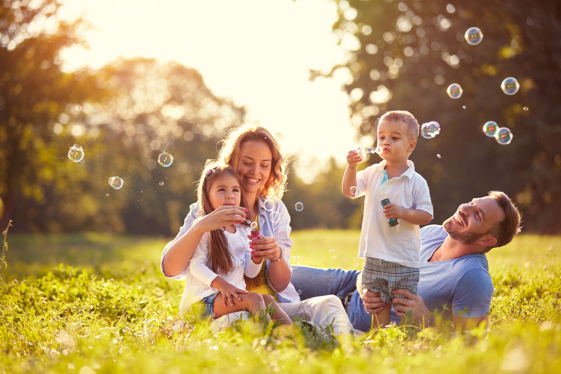 Family with children blow soap bubbles Family with children blow soap bubbles